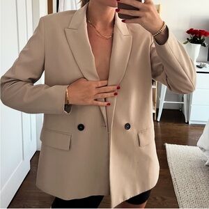Tan blazer with black buttons
